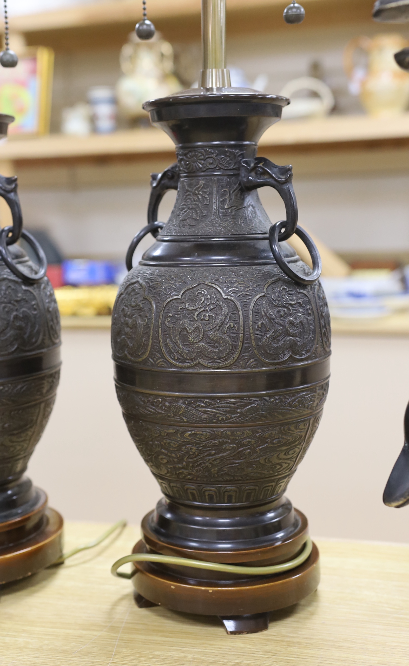 A pair of Japanese archaistic bronze vases mounted as table lamps, 70cm total height